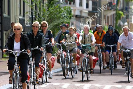 People riding bicycles on the street in Amsterdam, Netherlands.