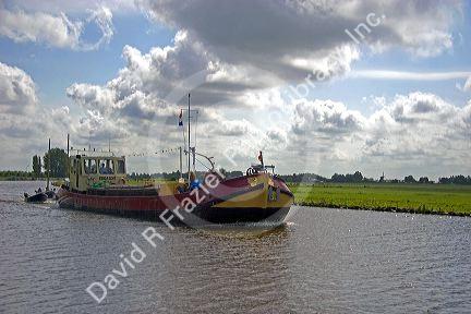 Boat traveling on a canal east of Leiden in the province of South Holland, Netherlands.