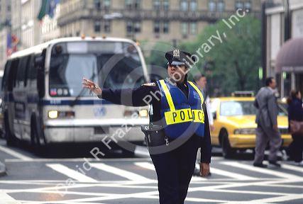 African american female police officer in New York City directing traffic.