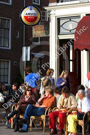 People eat and drink at an outdoor cafe in Amsterdam, Netherlands.
