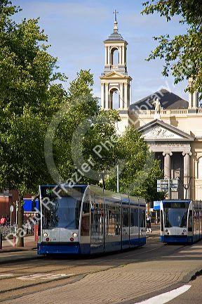 A tram line passes in front of the Mozes en Aaronkerk church at Waterloo Plein in Amsterdam, Netherlands.