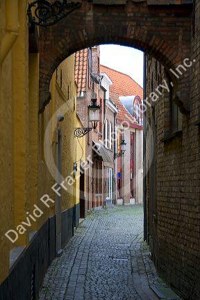 Narrow walking street in Bruges in the province of West Flanders, Belgium.
