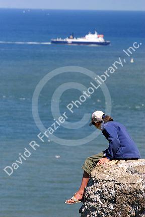 A woman takes in the view from Cap Blanc Nez in the Pas-de-Calais department in Northern France, sitting atop a German gun battery.
