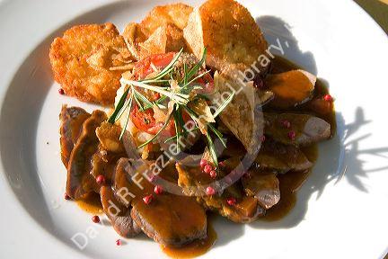 A dish of pork tenderloin and potato at a restaurant near Le Mont Saint Michel in the region of Basse-Normandie, France.