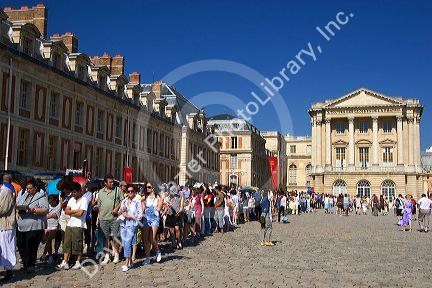 Tourists wait in line at The Palace of Versailles at Versailles in the department of Yvelines, France.