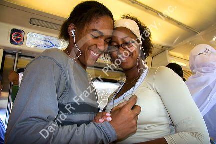 French students listen to an MP3 player on the train in Paris, France.