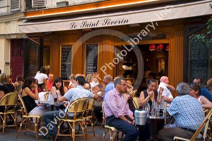 People dine at an outdoor cafe in Paris, France.