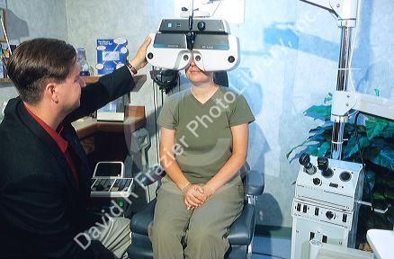 Optomitrist giving an eye exam.