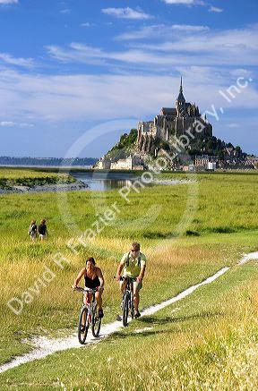 Bicyclists ride on trails near Le Mont Saint Michel in the region of Basse-Normandie, France.