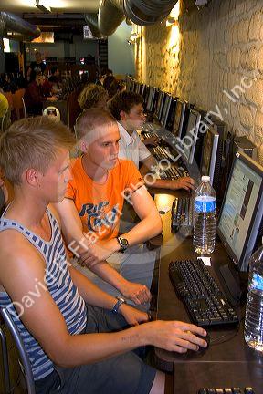People use computers at an internet cafe in Paris, France.