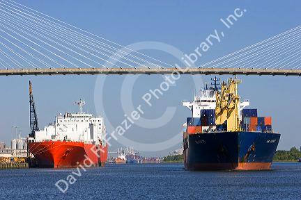 Container ships pass under the Talmadge Memorial Bridge at the Port of Savannah in Savannah, Georgia.