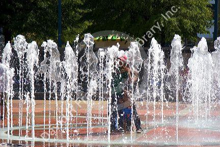 People get wet in the Fountain of Rings in Centennial Olympic Park, Atlanta, Georgia.
