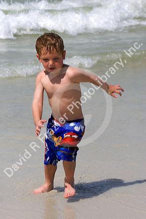 Three year old child playing at the beach in St. Petersburg, Florida. MR