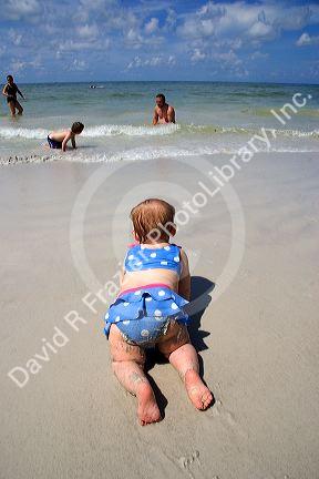 Infant crawling on the beach in St. Petersburg, Florida. MR