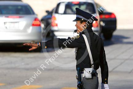 Female police officer directing traffic in Mexico City, Mexico.