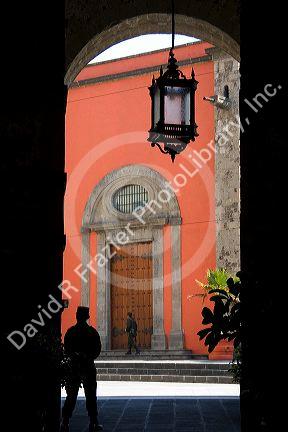 A guard stands in an archway at the National Palace in Mexico City, Mexico.
