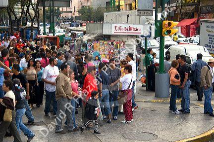 Pedestrians at the intersection of Paseo de la Reforma and Eje Central Lazaro Cardenas in Mexico City, Mexico.