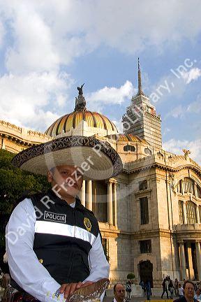 A police officer wearing a sombrero in front of the Palace of Fine Arts in Mexico City, Mexico.
