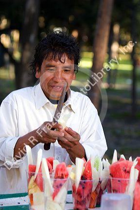Mexican street vendor selling fresh fruit cups in Mexico City, Mexico.