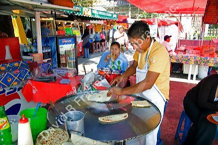 Mexican food vendor making quesadillas in Mexico City, Mexico.