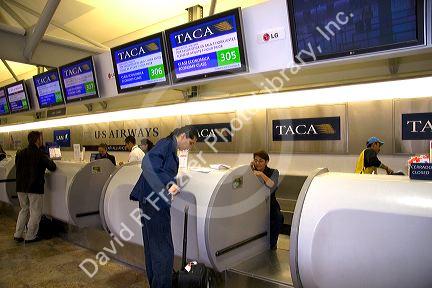 Travelers at the TACA airlines ticket counter at the Mexico City International Airport in Mexico City, Mexico.