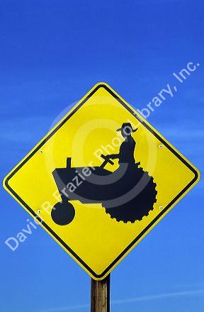 Road sign warning of tractor crossing.