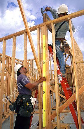 Hispanic construction workers framing a new home in Boise, Idaho.