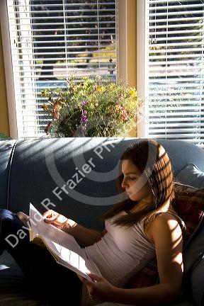Young woman reading a book. MR