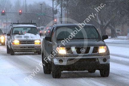 Automobiles driving on snow covered roads in Boise, Idaho.