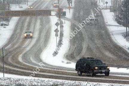 Automobiles driving on a snowy day in Boise, Idaho.
