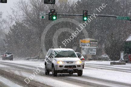 Automobiles driving on a snowy day in Boise, Idaho.