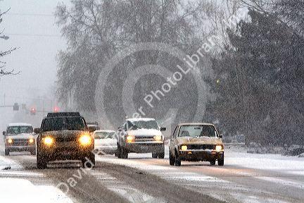 Automobiles driving on a snowy day in Boise, Idaho.