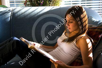 Young woman reading a book. MR