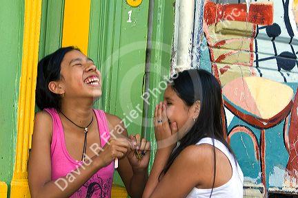 Young Argentine girls laughing in the La Boca barrio of Buenos Aires, Argentina.