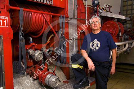 Chilean firefighter standing next to a fire truck at Valparaiso, Chile.