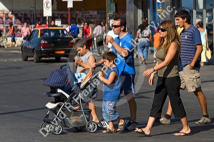 Family eating ice cream while crossing the street in Valparaiso, Chile.