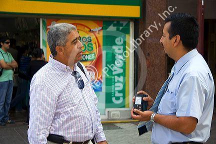 Businessmen talking on the Paseo Ahumada in Santaigo, Chile.