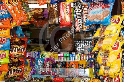 Woman sellling snacks and magazines from a kiosk on the Paseo Ahumada in Santiago, Chile.