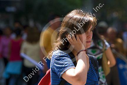 Woman using a cell phone on the Paseo Ahumada in Santiago, Chile.