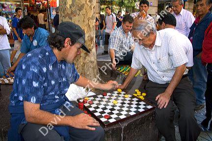 Chilean men play checkers in the Plaza de Armas in Santiago, Chile.