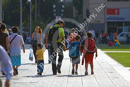 Father walking with his sons in Santiago, Chile.