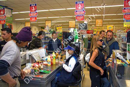 Customers in the check out line of a super market in El Calafate, Patagonia, Argentina.