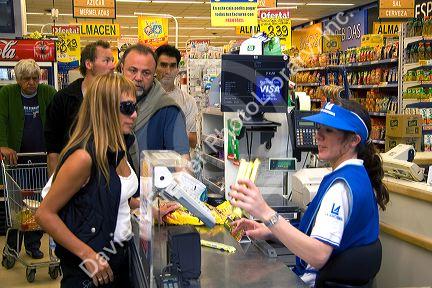 Customers in the check out line of a super market in El Calafate, Patagonia, Argentina.