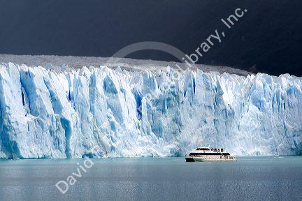 Tour boat in front of the Perito Moreno Glacier located in the Los Glaciares National Park in the south west of Santa Cruz province, Patagonia, Argentina.