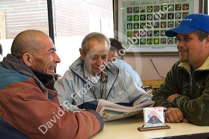 Argentine men socialize in the Panaderia Union bakery at Tolhuin, Tierra del Fuego, Argentina.