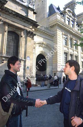 French students greet with a handshake.