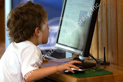 Three year old British boy using a computer at Ushuaia, Tierra del Fuego, Argentina.