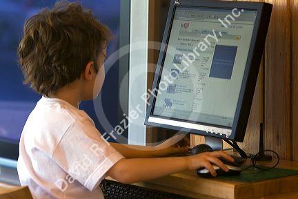 Three year old British boy using a computer at Ushuaia, Tierra del Fuego, Argentina.