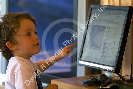 Three year old British boy using a computer at Ushuaia, Tierra del Fuego, Argentina.
