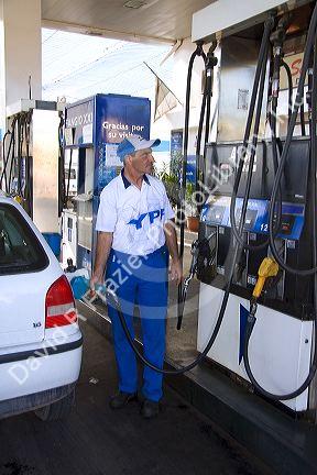 YFP gas station attendent fueling up a car in Mendoza, Argentina.
